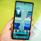 A photo of a hand holding the Pixel 6a